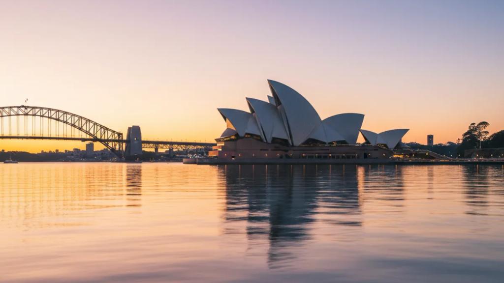 Traveler at Sydney Harbour at dusk checking whether their phone has signal