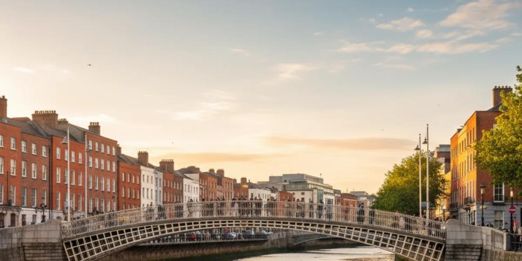 The Ha'penny Bridge arching over the River Liffey in Dublin at dusk